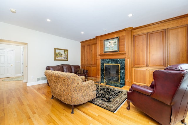 66 Great Pond Rd, Glastonbury, CT 06073 - living room featuring a premium fireplace, light wood-style floors, baseboards, and recessed lighting