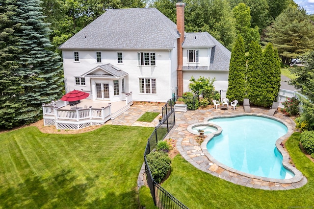 66 Great Pond Rd, Glastonbury, CT 06073 - back of property with a wooden deck, a chimney, a shingled roof, a pool with connected hot tub, and a patio