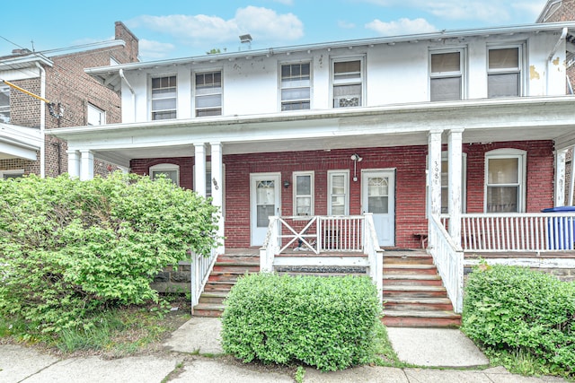 400 E Ave, Bridgeport, CT 06610 - view of front facade with a porch, stairs, and brick siding