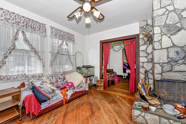400 E Ave, Bridgeport, CT 06610 - bedroom featuring wood finished floors, a stone fireplace, and a ceiling fan