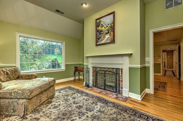 16 Black Rock Tpke, Redding, CT 06896 - living room with wood finished floors, a brick fireplace, and baseboards