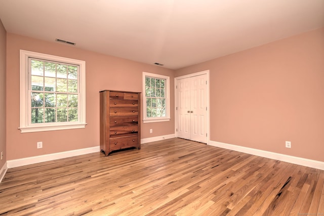 16 Black Rock Tpke, Redding, CT 06896 - unfurnished bedroom featuring light wood-style flooring, baseboards, and a closet