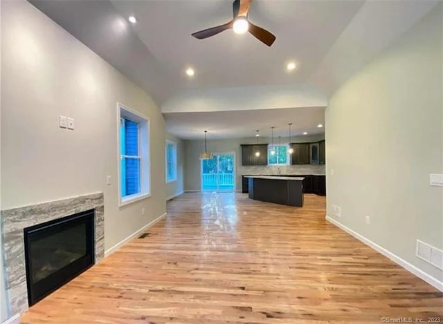LOT5 Ratlum Mountain Rd, Barkhamsted, CT 06063 - unfurnished living room with a stone fireplace, light wood-style flooring, a ceiling fan, baseboards, and recessed lighting