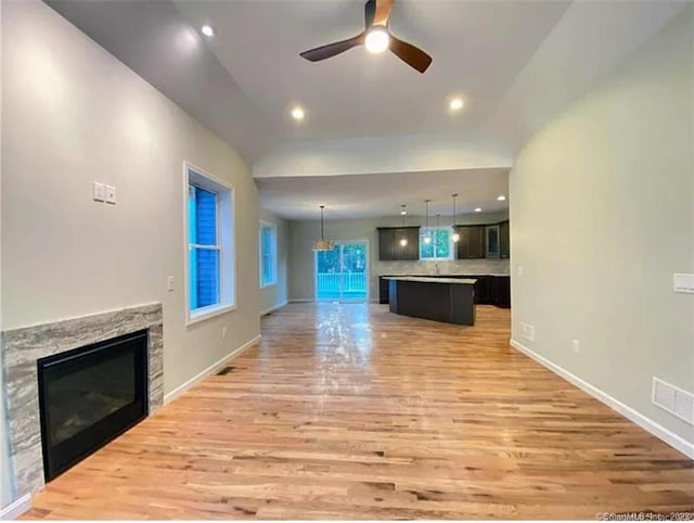 LOT5 Ratlum Mountain Rd, Barkhamsted, CT 06063 - unfurnished living room with light wood-type flooring, a stone fireplace, a ceiling fan, baseboards, and recessed lighting