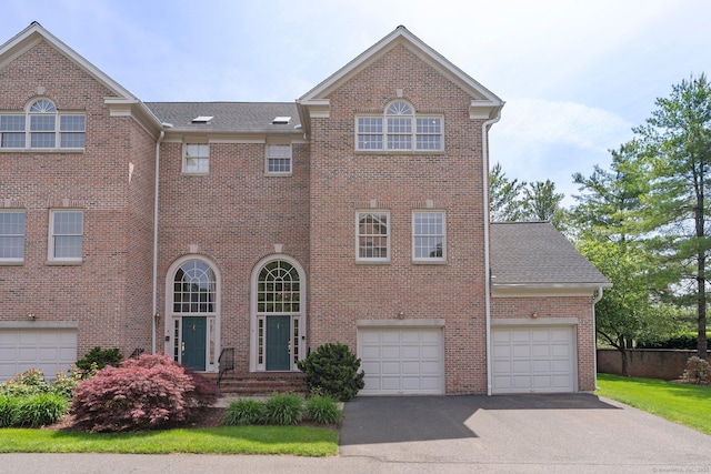 2 Governors Row Unit 2, West Hartford, CT 06117 - view of front of home featuring driveway, brick siding, and roof with shingles