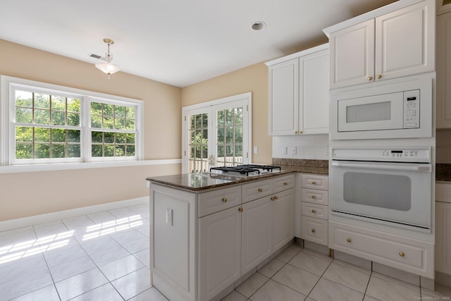 2 Governors Row Unit 2, West Hartford, CT 06117 - kitchen featuring white appliances, healthy amount of natural light, and light tile patterned flooring