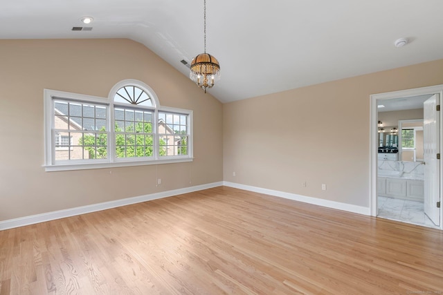 2 Governors Row Unit 2, West Hartford, CT 06117 - unfurnished room featuring a chandelier, light wood-style flooring, vaulted ceiling, a smoke detector, and baseboards