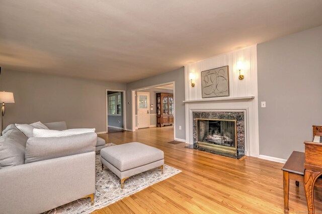 691 Buttonball Rd, Orange, CT 06477 - living area with light wood-style flooring, a premium fireplace, and baseboards