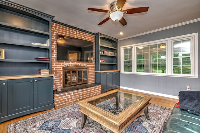 691 Buttonball Rd, Orange, CT 06477 - living room with wood finished floors, a ceiling fan, a brick fireplace, ornamental molding, and baseboards