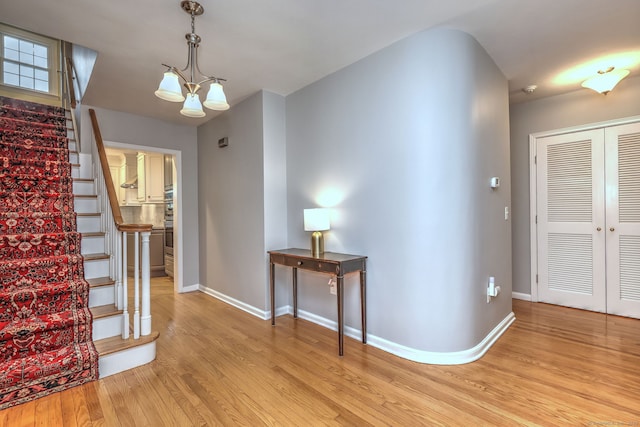 691 Buttonball Rd, Orange, CT 06477 - foyer featuring stairway, light wood-style floors, and baseboards