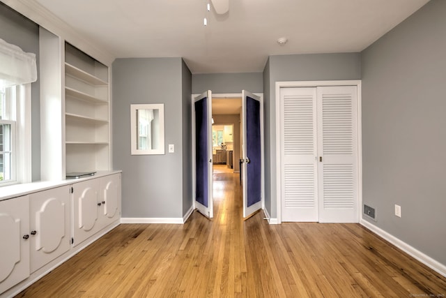 691 Buttonball Rd, Orange, CT 06477 - unfurnished bedroom with light wood-style floors, a closet, baseboards, and a ceiling fan