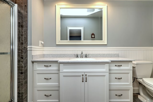 691 Buttonball Rd, Orange, CT 06477 - bathroom featuring vanity, toilet, a shower stall, and a wainscoted wall