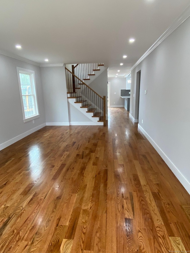 285 Alba Ave, Bridgeport, CT 06606 - unfurnished living room featuring crown molding, stairs, wood finished floors, and recessed lighting