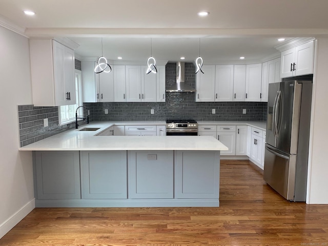 285 Alba Ave, Bridgeport, CT 06606 - kitchen featuring stainless steel appliances, wall chimney range hood, a peninsula, light countertops, and recessed lighting