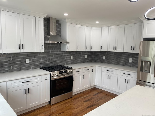285 Alba Ave, Bridgeport, CT 06606 - kitchen with appliances with stainless steel finishes, wall chimney exhaust hood, light countertops, dark wood-style flooring, and white cabinets