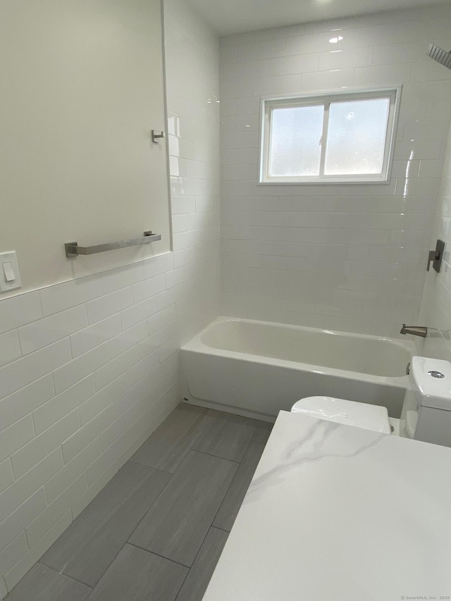 285 Alba Ave, Bridgeport, CT 06606 - bathroom with tile walls and shower / tub combination