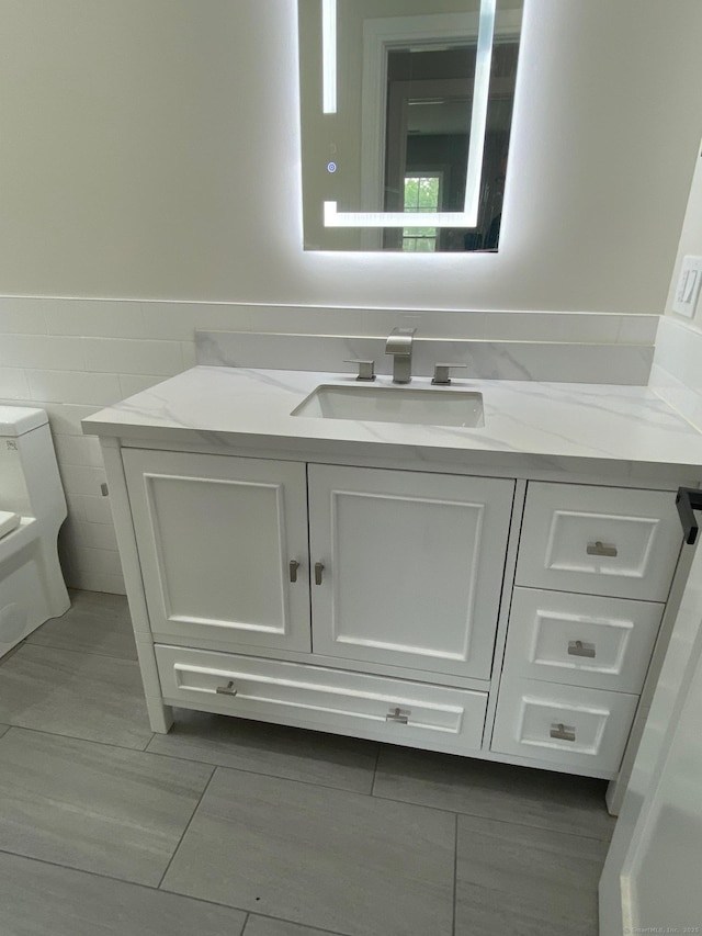 285 Alba Ave, Bridgeport, CT 06606 - bathroom with vanity, tile walls, and wainscoting