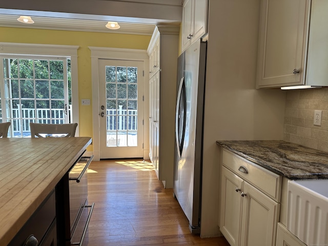1666 Ridge Rd, North Haven, CT 06473 - kitchen featuring freestanding refrigerator, tasteful backsplash, hardwood / wood-style floors, and dark stone counters