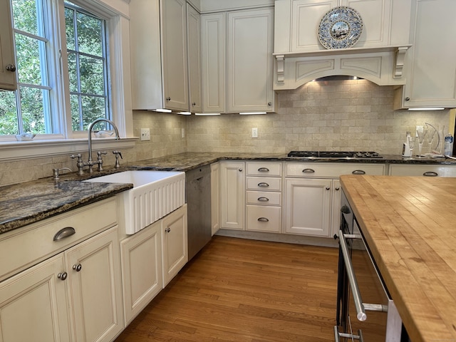 1666 Ridge Rd, North Haven, CT 06473 - kitchen featuring wood counters, appliances with stainless steel finishes, decorative backsplash, and light wood-style flooring