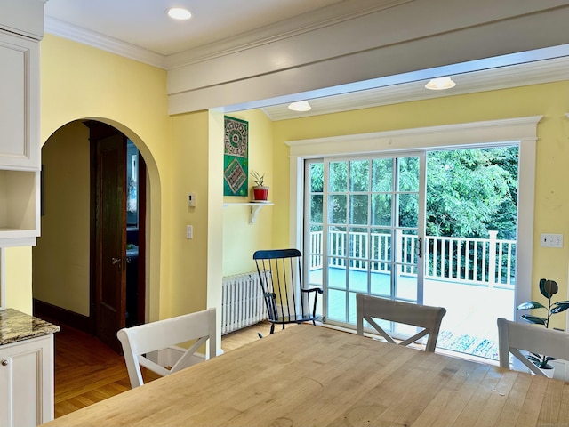 1666 Ridge Rd, North Haven, CT 06473 - dining space featuring radiator heating unit, arched walkways, plenty of natural light, and ornamental molding