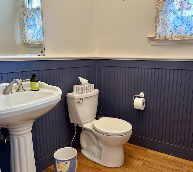 1666 Ridge Rd, North Haven, CT 06473 - half bathroom with wood finished floors and a wainscoted wall