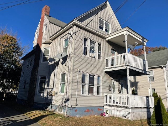 357 Blohm St, West Haven, CT 06516 - rear view of house featuring a chimney, a balcony, and a porch
