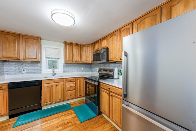 92 Blakeslee Ave, North Haven, CT 06473 - kitchen featuring stainless steel appliances, a sink, backsplash, and light countertops