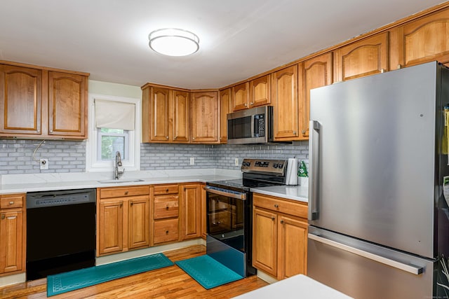 92 Blakeslee Ave, North Haven, CT 06473 - kitchen with stainless steel appliances, a sink, decorative backsplash, and light countertops