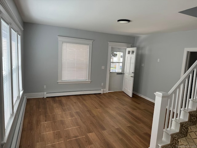 187 Jewett Ave, Bridgeport, CT 06606 - foyer with baseboard heating, wood finished floors, stairway, and baseboards