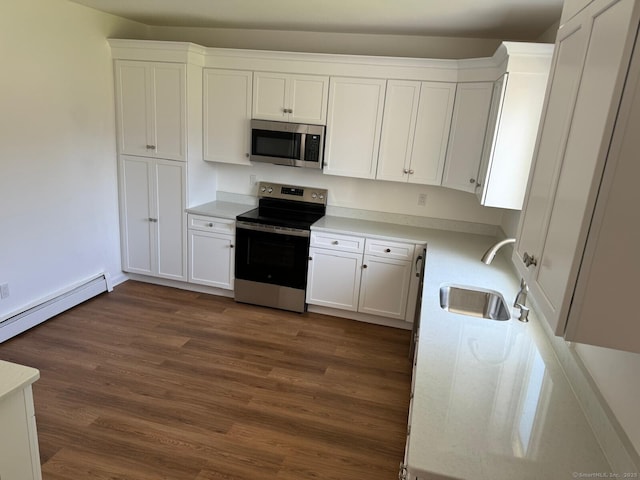 187 Jewett Ave, Bridgeport, CT 06606 - kitchen featuring appliances with stainless steel finishes, a sink, dark wood finished floors, and white cabinetry
