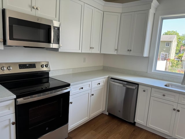 187 Jewett Ave, Bridgeport, CT 06606 - kitchen with stainless steel appliances, healthy amount of natural light, white cabinetry, and light countertops