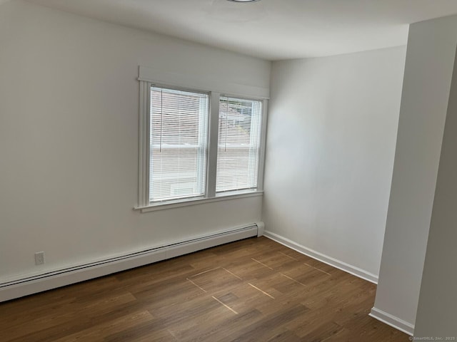 187 Jewett Ave, Bridgeport, CT 06606 - spare room featuring a baseboard heating unit, dark wood-style floors, and baseboards
