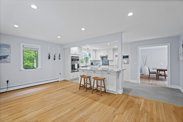 21 Corrina Ln, Salem, CT 06420 - kitchen featuring double oven, light wood-style floors, healthy amount of natural light, white cabinetry, and recessed lighting