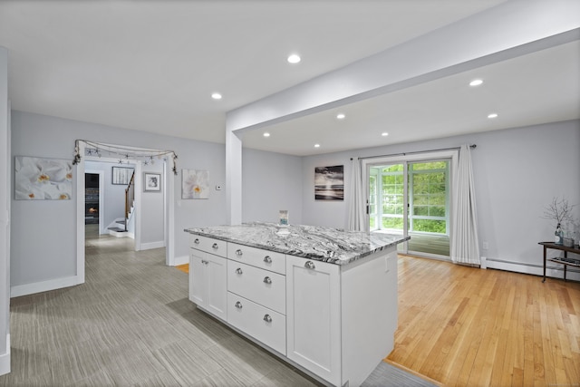 21 Corrina Ln, Salem, CT 06420 - kitchen with white cabinetry, a baseboard heating unit, a kitchen island, light stone countertops, and recessed lighting