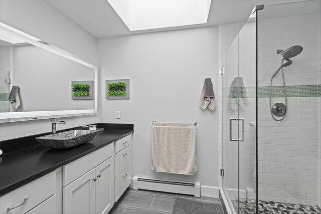 21 Corrina Ln, Salem, CT 06420 - bathroom with baseboard heating, vanity, a stall shower, tile patterned flooring, and baseboards
