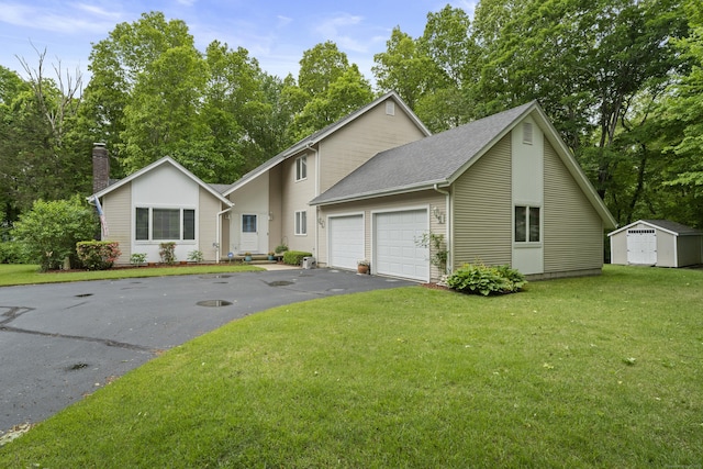 21 Corrina Ln, Salem, CT 06420 - view of front of property with asphalt driveway, an attached garage, a front yard, and a chimney