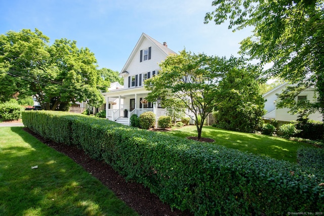 10 Fairfield Ave, Darien, CT 06820 - view of front of house featuring a front yard, covered porch, and a chimney