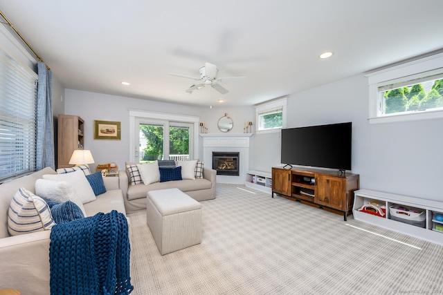 10 Fairfield Ave, Darien, CT 06820 - carpeted living area with healthy amount of natural light, a glass covered fireplace, ceiling fan, and recessed lighting