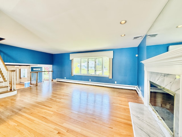 12 Rolling Ln, Norwalk, CT 06851 - unfurnished living room with a baseboard heating unit, a high end fireplace, wood finished floors, stairway, and recessed lighting