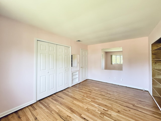 12 Rolling Ln, Norwalk, CT 06851 - unfurnished bedroom featuring wood finished floors, baseboards, and a closet