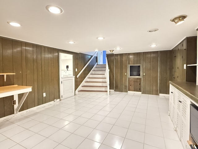 12 Rolling Ln, Norwalk, CT 06851 - unfurnished living room with wooden walls, stairway, and recessed lighting