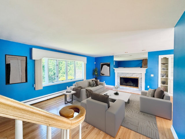 12 Rolling Ln, Norwalk, CT 06851 - living room with baseboard heating, wood finished floors, a fireplace, built in features, and baseboards