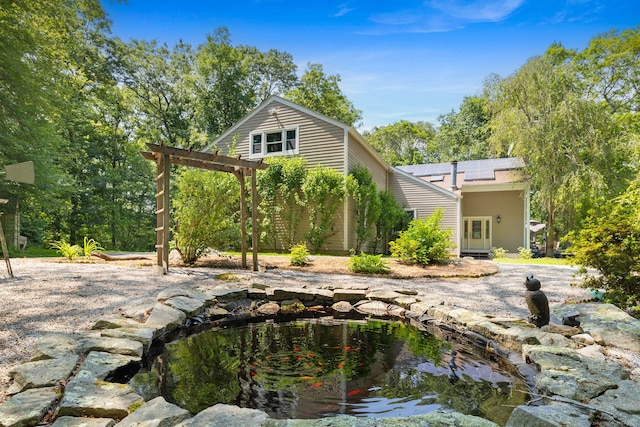 254 Haley Rd, Groton, CT 06355 - back of property featuring solar panels and a garden pond