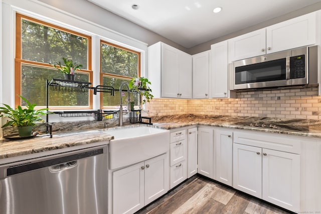254 Haley Rd, Groton, CT 06355 - kitchen with appliances with stainless steel finishes, wood finished floors, white cabinets, backsplash, and recessed lighting