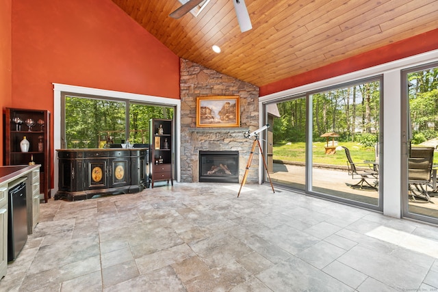 254 Haley Rd, Groton, CT 06355 - unfurnished living room featuring a ceiling fan, healthy amount of natural light, high vaulted ceiling, a fireplace, and wood ceiling