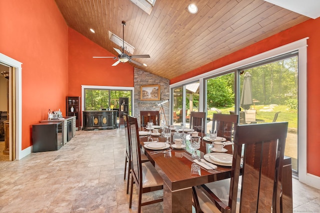 254 Haley Rd, Groton, CT 06355 - dining space featuring stone finish floors, wooden ceiling, high vaulted ceiling, ceiling fan, and a skylight