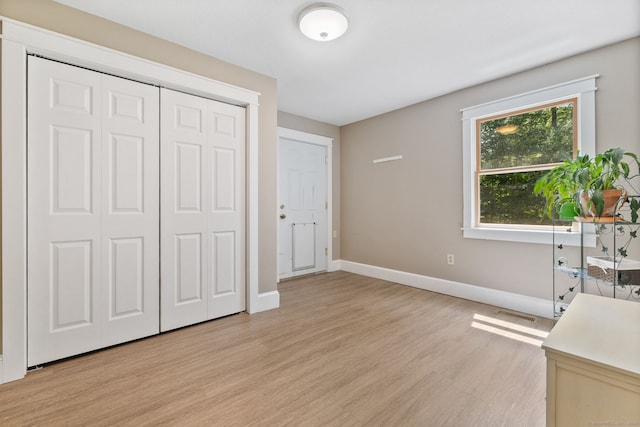 254 Haley Rd, Groton, CT 06355 - unfurnished bedroom with light wood finished floors and a closet