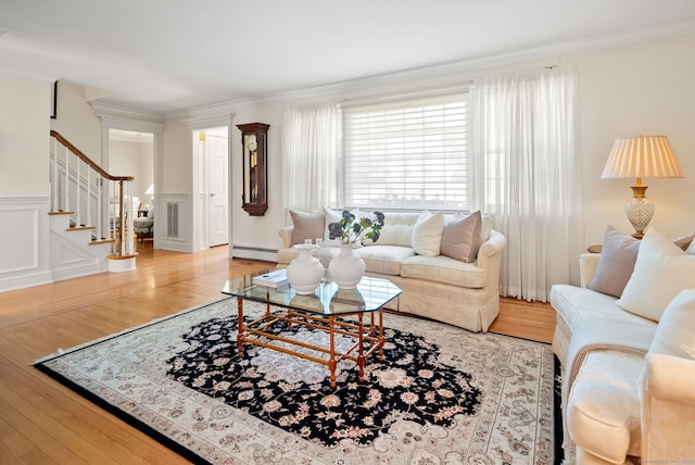 129 Brookmere Dr, Fairfield, CT 06824 - living room with stairway, ornamental molding, light wood finished floors, a baseboard heating unit, and a wainscoted wall