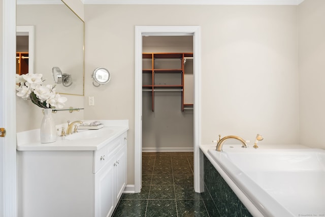 129 Brookmere Dr, Fairfield, CT 06824 - bathroom with vanity, a spacious closet, a garden tub, and tile patterned floors