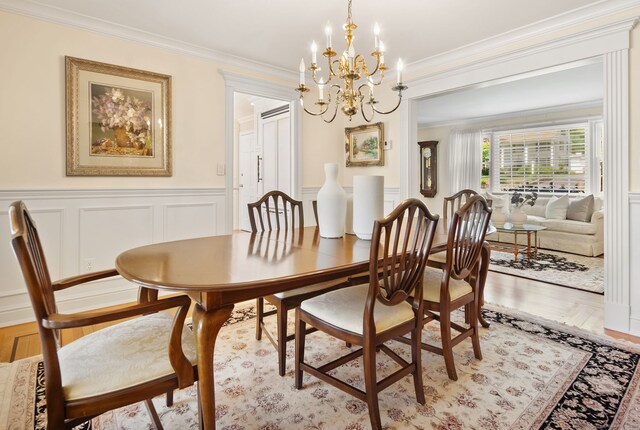 129 Brookmere Dr, Fairfield, CT 06824 - dining space featuring a chandelier, ornamental molding, a decorative wall, and a wainscoted wall